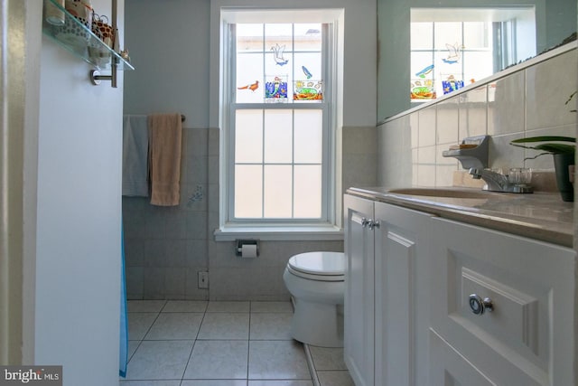 bathroom featuring vanity, tile walls, tile patterned floors, and toilet