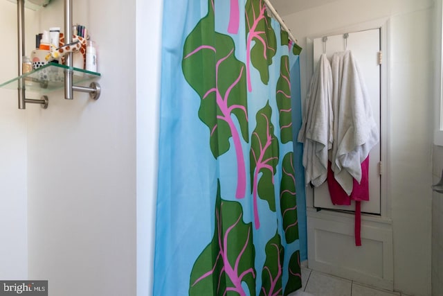 bathroom featuring curtained shower and tile patterned floors