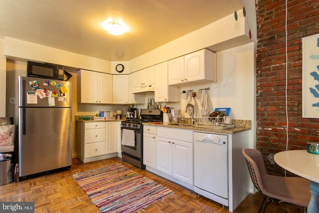 kitchen with stainless steel fridge, black gas stove, dishwasher, white cabinets, and light parquet floors