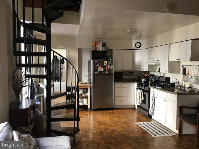 kitchen featuring white cabinetry, appliances with stainless steel finishes, sink, and dark parquet floors