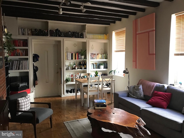 living room featuring dark parquet floors and beam ceiling