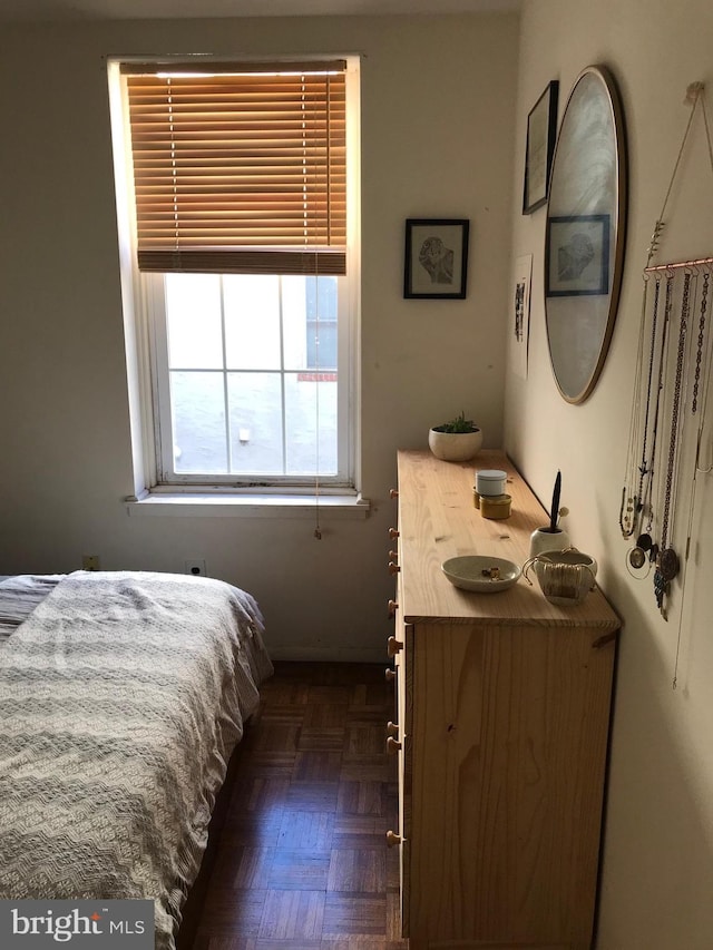 bedroom featuring dark parquet flooring