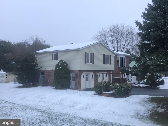 front of property featuring central air condition unit and a wooden deck