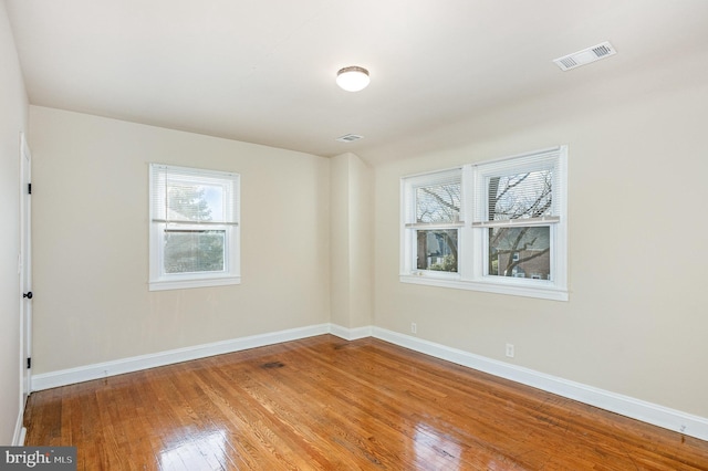 spare room with hardwood / wood-style flooring