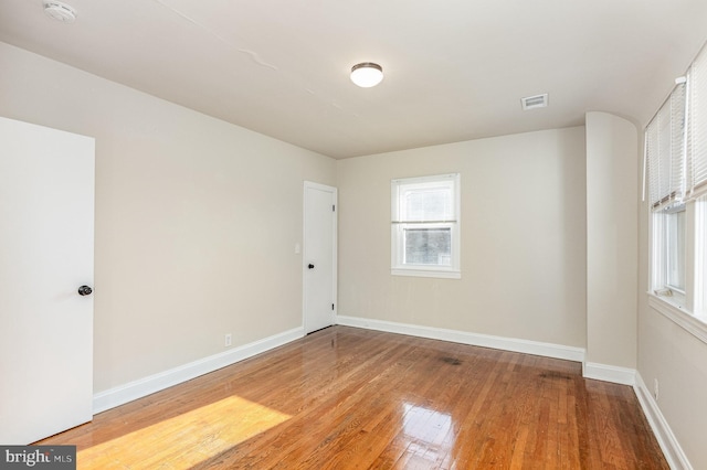 unfurnished room featuring hardwood / wood-style flooring