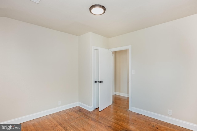 unfurnished room with wood-type flooring