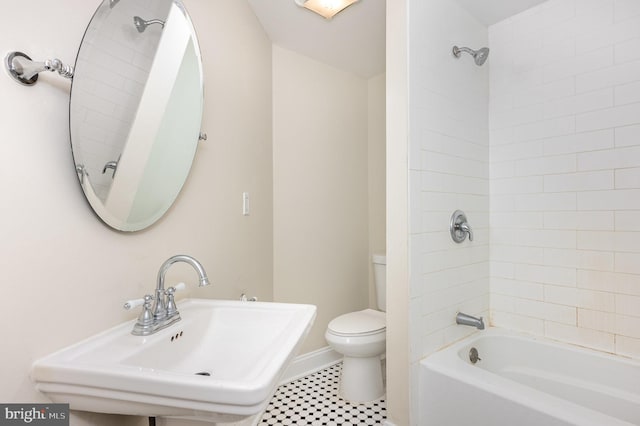 full bathroom with toilet, tiled shower / bath, and sink