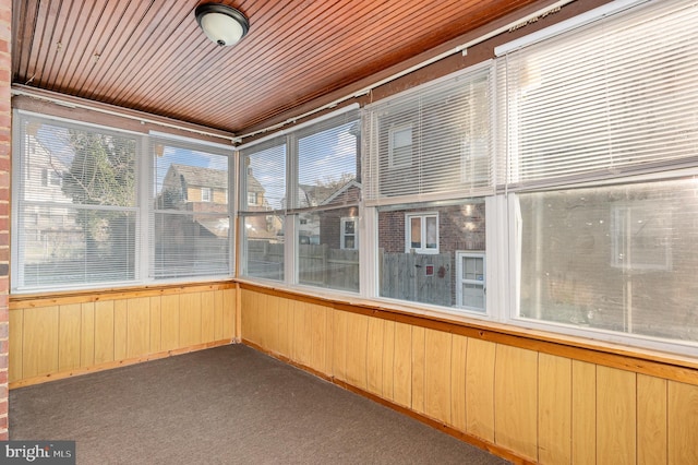 unfurnished sunroom with wooden ceiling