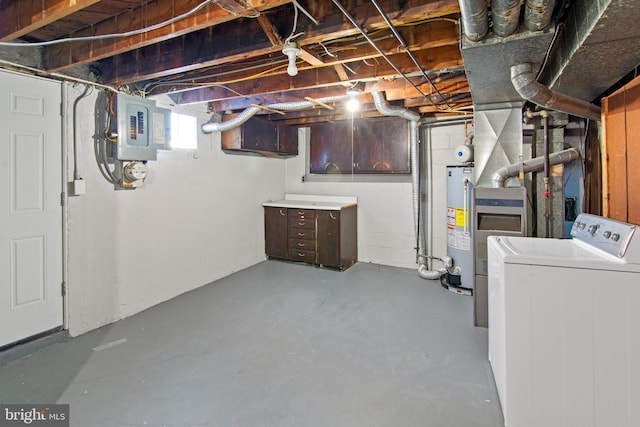 basement featuring electric panel, gas water heater, and washer / clothes dryer