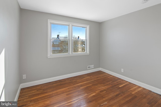 spare room featuring dark hardwood / wood-style floors