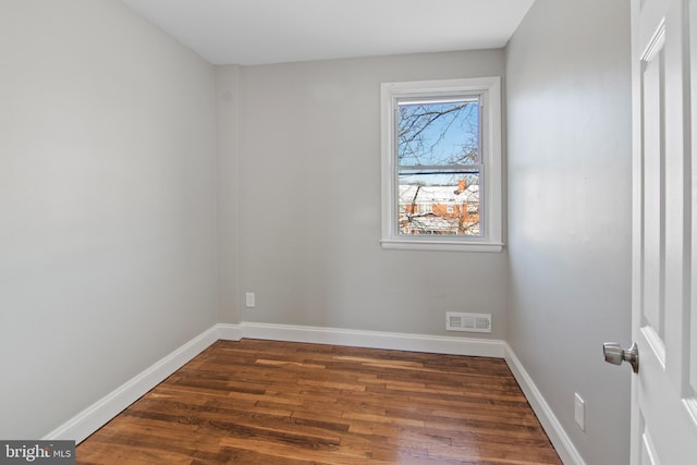 spare room with dark wood-type flooring