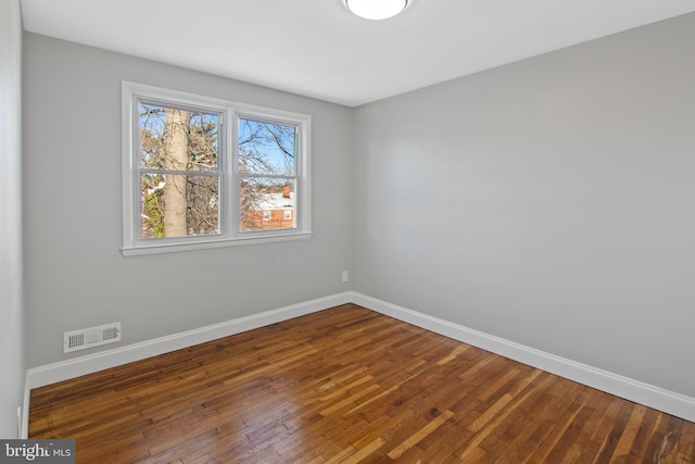 spare room featuring hardwood / wood-style floors