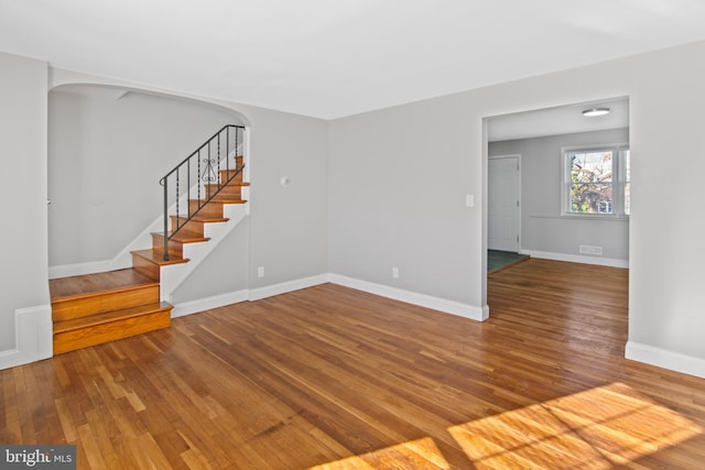 unfurnished living room with wood-type flooring