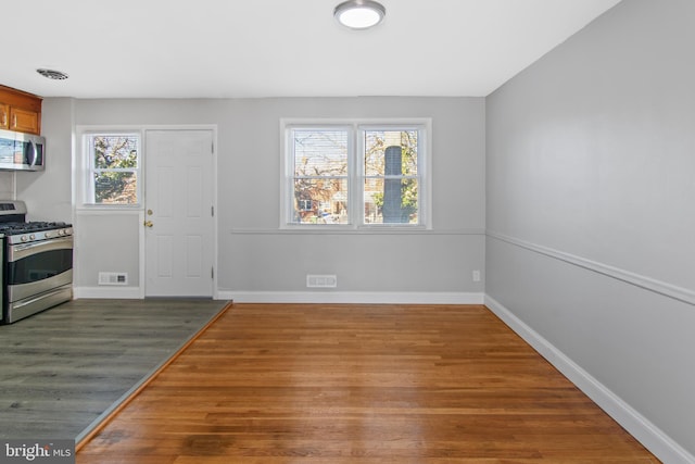 interior space featuring wood-type flooring and stainless steel appliances