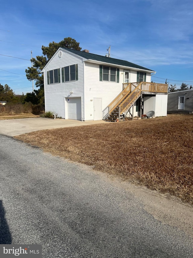 view of front of property featuring a garage and a deck