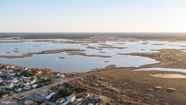 snowy aerial view with a water view