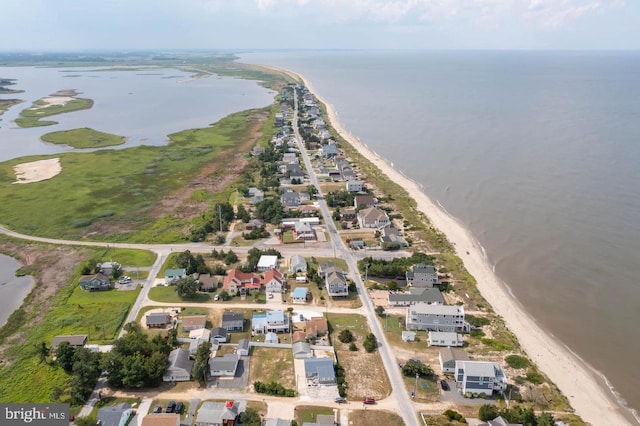 bird's eye view featuring a water view and a beach view