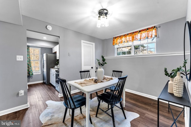 dining space featuring dark hardwood / wood-style floors