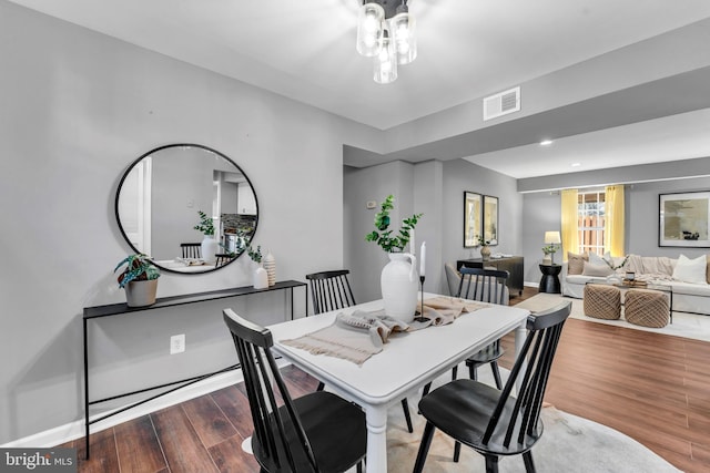 dining room with dark hardwood / wood-style flooring