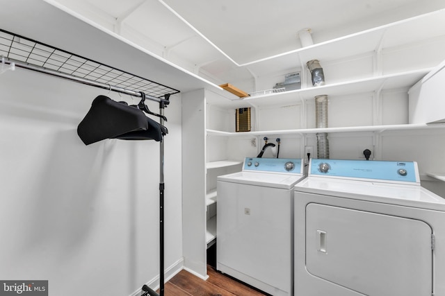 laundry area featuring washing machine and clothes dryer and dark hardwood / wood-style floors