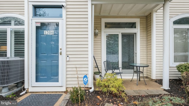 doorway to property featuring central air condition unit