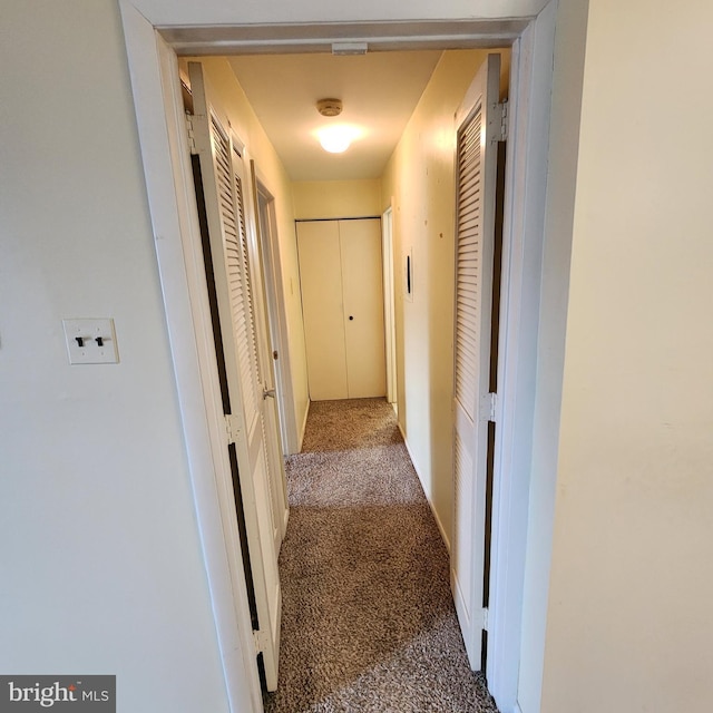 corridor with carpet flooring