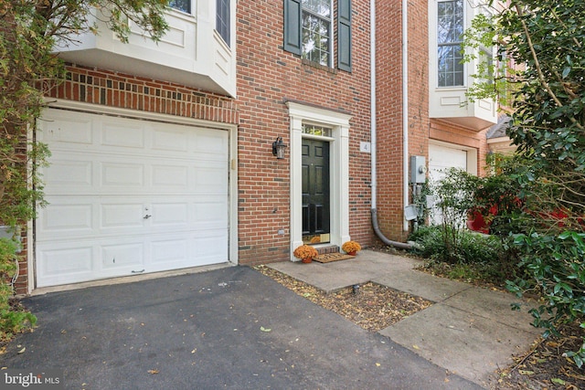 view of exterior entry with a garage