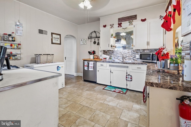 kitchen featuring sink, backsplash, decorative light fixtures, white cabinets, and appliances with stainless steel finishes