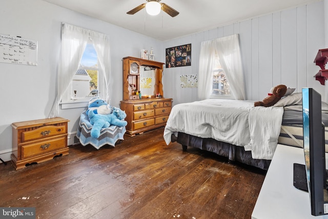 bedroom featuring multiple windows, ceiling fan, and dark wood-type flooring