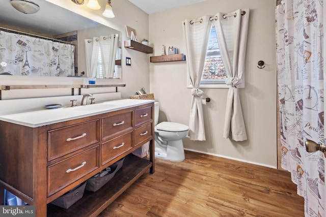 bathroom with vanity, hardwood / wood-style flooring, and toilet