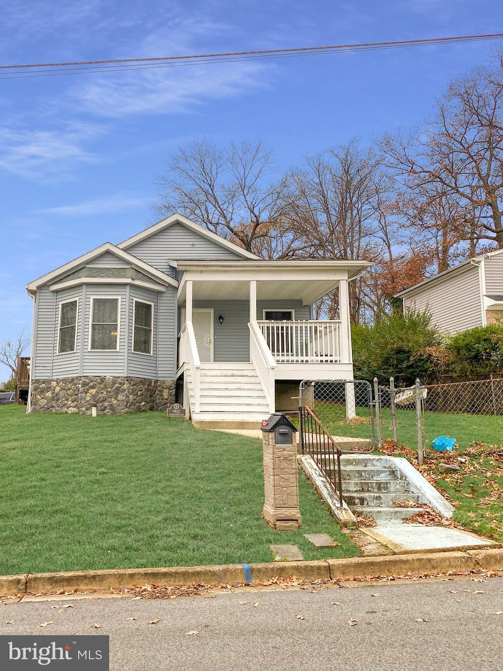 bungalow featuring a porch and a front lawn