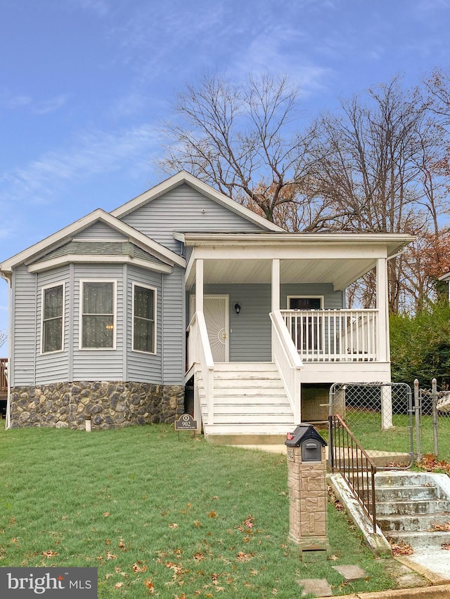 view of front of home with a front yard and a porch