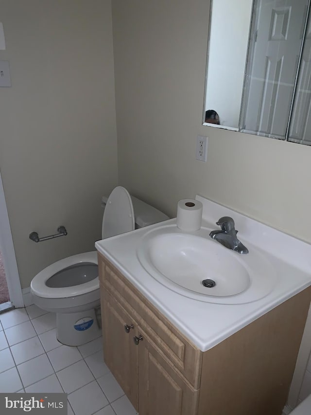 bathroom featuring tile patterned floors, vanity, and toilet