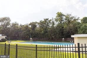 view of pool with a yard