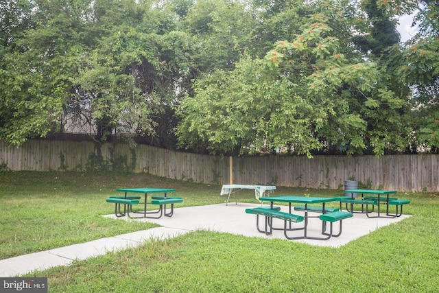 view of community with a yard and a patio