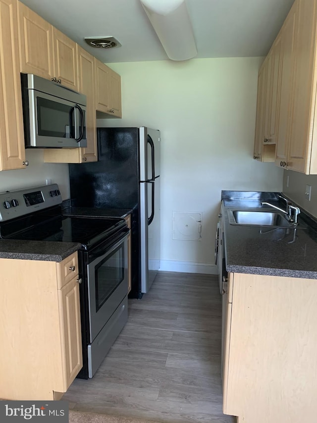 kitchen featuring light hardwood / wood-style floors, sink, stainless steel appliances, and light brown cabinetry