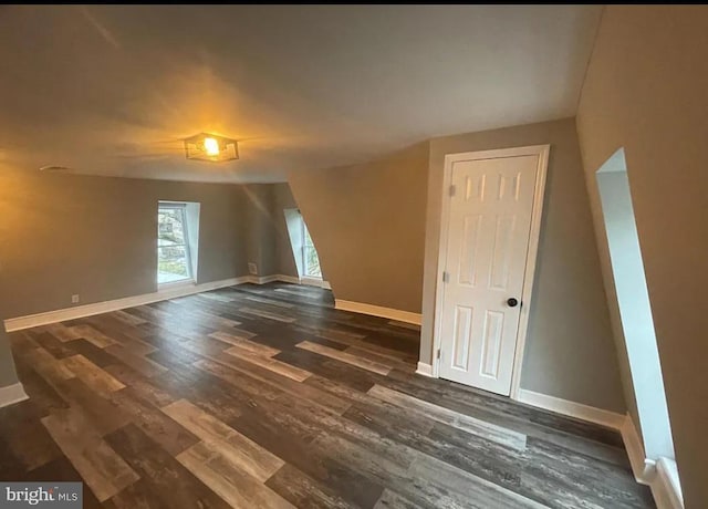 unfurnished room with dark hardwood / wood-style flooring