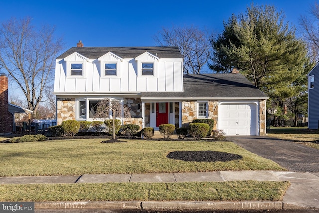 view of front of house with a front yard and a garage