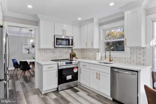 kitchen with white cabinetry, sink, and stainless steel appliances