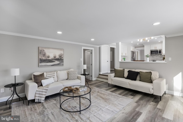 living room featuring hardwood / wood-style floors and crown molding