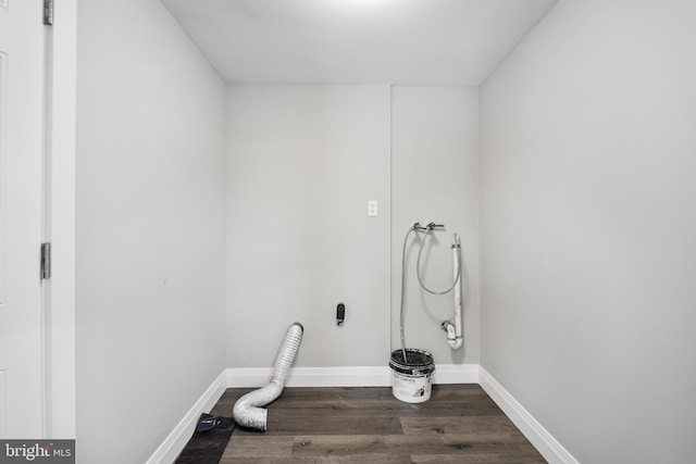 clothes washing area with hookup for an electric dryer, hookup for a washing machine, and dark hardwood / wood-style flooring