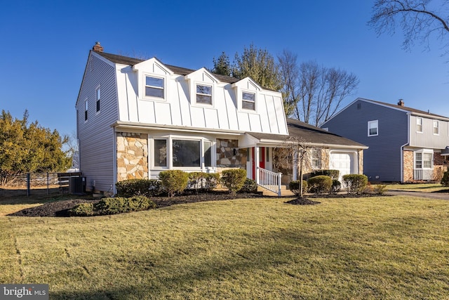 view of front of property with cooling unit, a front yard, and a garage