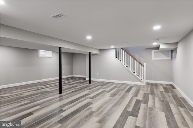 basement with light hardwood / wood-style flooring