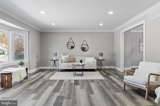 sitting room featuring hardwood / wood-style flooring and crown molding