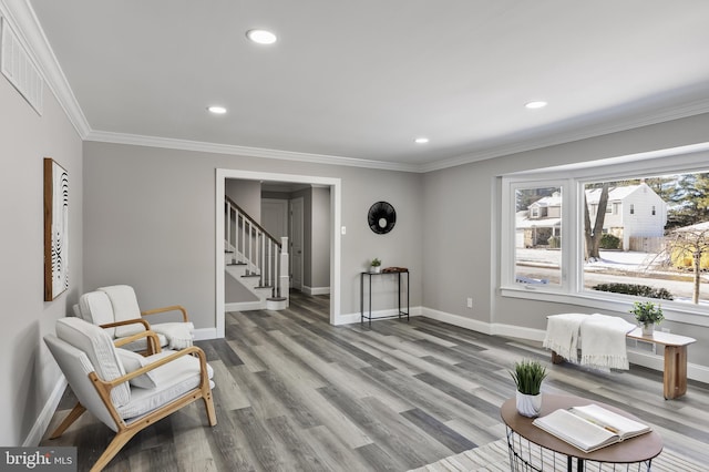 sitting room with light hardwood / wood-style flooring and ornamental molding