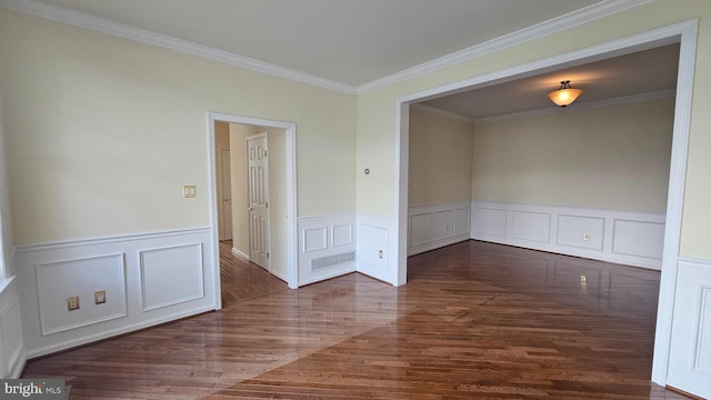 unfurnished room with crown molding and dark wood-type flooring