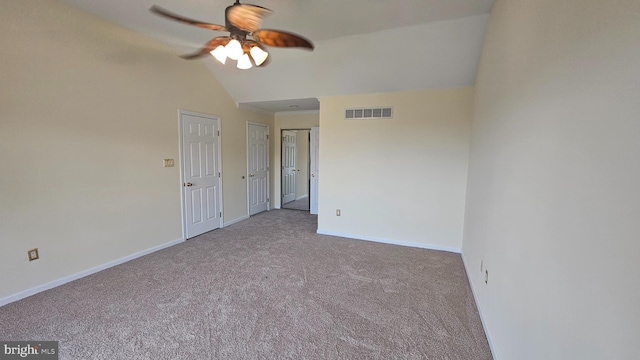 unfurnished room featuring ceiling fan, lofted ceiling, and carpet floors