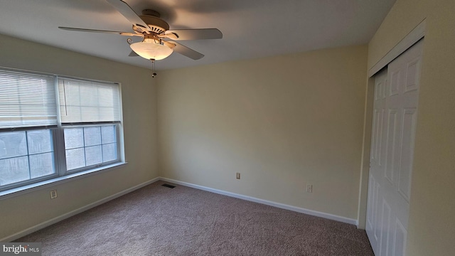 spare room featuring carpet flooring and ceiling fan