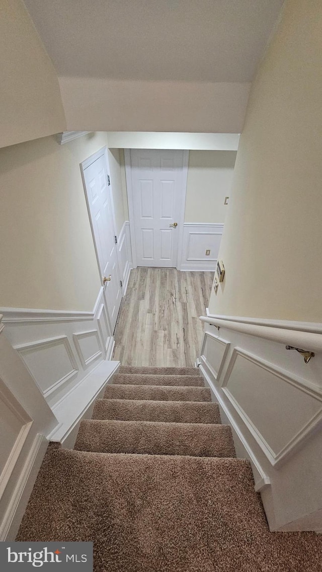 stairway featuring wood-type flooring