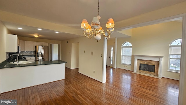 kitchen featuring stainless steel fridge, dark hardwood / wood-style floors, a wealth of natural light, and sink